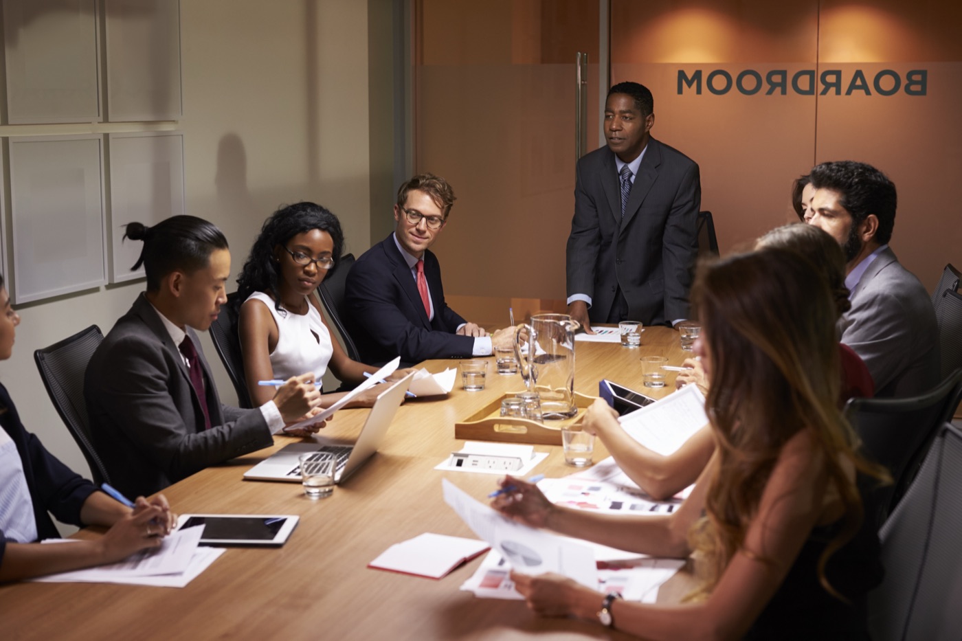 A leadership team meeting around a boardroom table